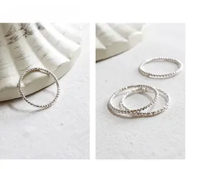 Macro view of sterling silver faceted thin rings with sparkling diamond-cut texture