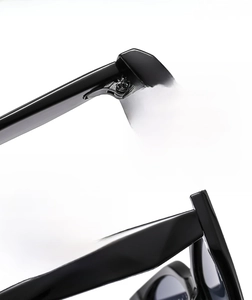 Detail view of durable metal hinges and textured cat-eye frame of fashion sunglasses