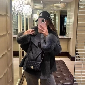 Elegant grey wool coat for women with oversized faux fur cuffs and a classic lapel collar