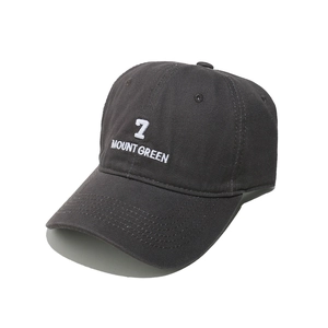 Detail of dark grey baseball cap featuring white 7 MOUNT GREEN 3D embroidery texture