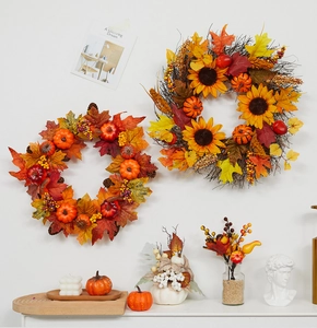 Close-up of autumn wreaths with maple leaves, pumpkins, and sunflowers for fall decor