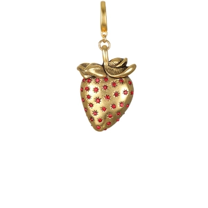 Close-up of golden strawberry pendant featuring sparkling red rhinestones and 18K plating