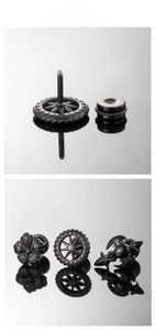 Detail of black stainless steel gear and gothic bat stud earrings with screw back