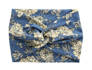 Close-up of navy blue floral elastic headband with a twisted knot for yoga and sports
