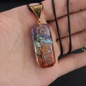 Detail of resin rectangle pendant with colorful crystal stones and copper spiral wire