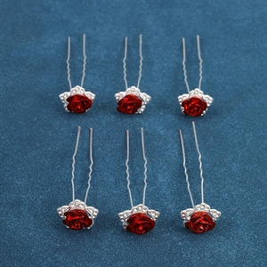 Detail of red rose bridal hair pins with sparkling rhinestones and U-shaped alloy base
