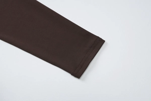 Close-up detail of dark brown long sleeve cuff with high-quality double stitching
