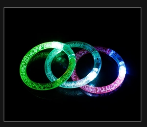 Detailed view of three glowing LED bubble bracelets in green, blue, and pink acrylic