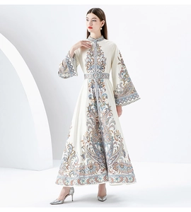 Detail of high collar bohemian print dress with long bell sleeves and floral patterns