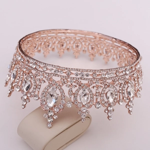 Macro detail of rose gold bridal crown with crystal teardrops and rhinestone tassels