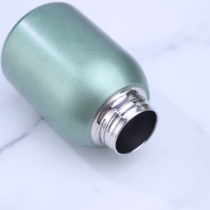 Detail of the screw thread and dark green matte finish on a stainless steel mini bottle