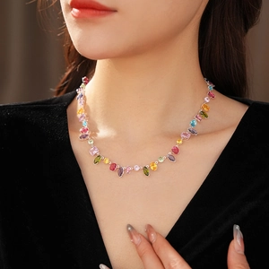 Detailed view of necklace featuring multi-color gemstones in teardrop and marquise cuts