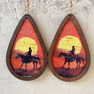 Teardrop wood framed earrings featuring a western cowboy sunset silhouette design