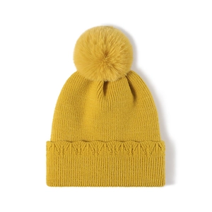 Bonnet en maille jaune moutarde pour femme avec grand pompon et motif cœur en relief
