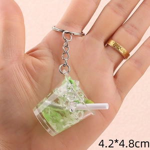 Miniature juice bucket keychain featuring green liquid, lime slices and ice cubes in 4.2x4.8cm
