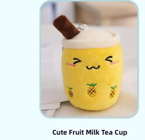 Close-up of yellow pineapple milk tea plush keychain with cute smiling face and metal hook