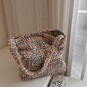 Detailed close-up of multi-color tweed woven shoulder bag with thick texture and retro style