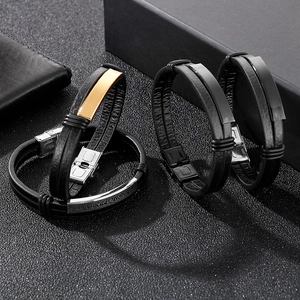 Detail of men's double-layer braided leather bracelets with gold, silver, and black metal plates