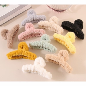 Flat lay of large plush shark hair claws in ten different colors for winter styling