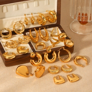 Detailed macro view of 18K gold plated stainless steel hollow hoop earrings and studs