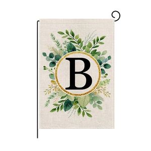 Garden flag with letter B and floral wreath on a black metal pole for outdoor decor