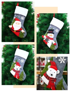 Close-up of gray felt Christmas stockings with 3D Santa, Snowman, and Polar Bear hanging