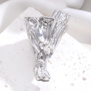 Detailed macro view of a silver bouquet brooch with a polished metallic mirror finish