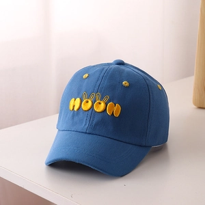 Close-up of the MOON embroidered lettering and rabbit ear design on the navy blue cotton cap
