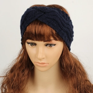 Detail of navy blue cable knit headband with twisted design on female model head