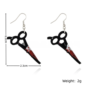 Detail view of Halloween scissors earrings with blood splatter print and silver hooks