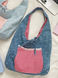 Blue denim bow heart tote bag with red gingham lace pocket shown with a laptop