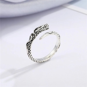 Macro view of vintage silver dragon ring showing intricate dragon scale carvings and detail