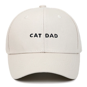 Close-up of black CAT DAD embroidery on a beige cotton baseball cap with curved brim