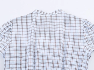 Detailed view of the plaid pattern and stitching on the collar of a short sleeve dress