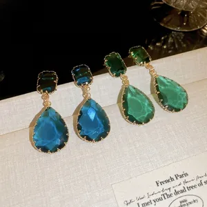 Luxe teardrop crystal earrings in sapphire blue and emerald green with gold claw settings