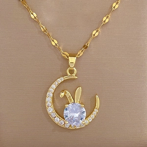 Macro detail of gold moon rabbit pendant necklace featuring sparkling zircon crystals