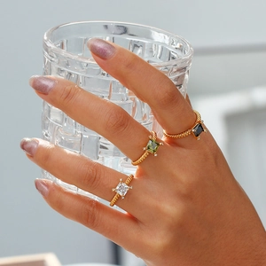 Close-up of 18K gold plated twisted rings with colorful square zircon stones on hand