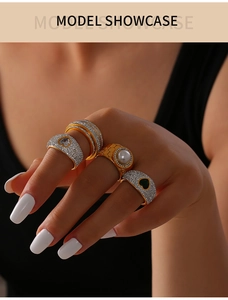 Close-up of luxury gold rings with micro-pave diamonds and freshwater pearl detail