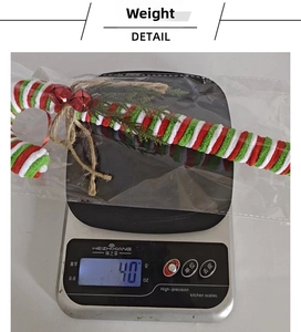 Detail showing a 40g Christmas candy cane hanging ornament on a scale for weight display