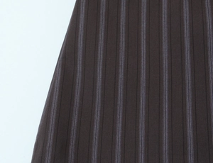 Detailed close-up of dark brown pinstripe fabric texture on slim-fit tailored shorts