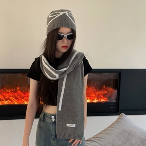 Gray knitted bow jacquard hat and scarf set with white stripes on a model
