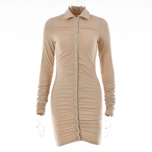 Close-up of khaki ruched shirt dress showing front button placket and pleated texture