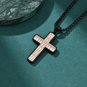 Modern stainless steel cross necklace with gold wave pattern on deep green marble background
