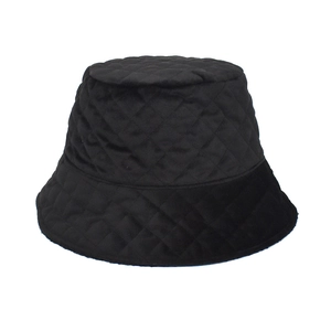 Detailed view of black quilted bucket hat with diamond stitching pattern for winter