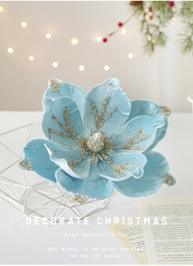 Close-up of velvet sky blue Christmas magnolia flower with glitter in white basket