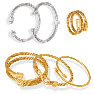 Twisted cable cuff bracelets and matching rings in gold and silver steel with zircons