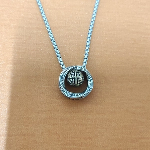 Silver Mobius pendant necklace with fret pattern and rotating transfer bead on box chain