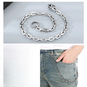 Macro detail of punk square link chain with skull clasp worn on denim jeans for men