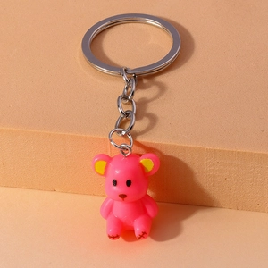 Detailed close-up of a cute pink bear keychain with resin finish and silver metal ring