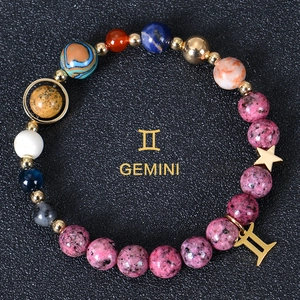 Macro detail of Gemini zodiac bracelet with 8mm natural stones and gold star charms